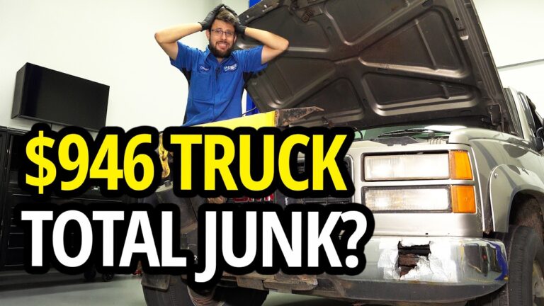 A rusted GMC K2500 truck being inspected for a budget yard plow project.