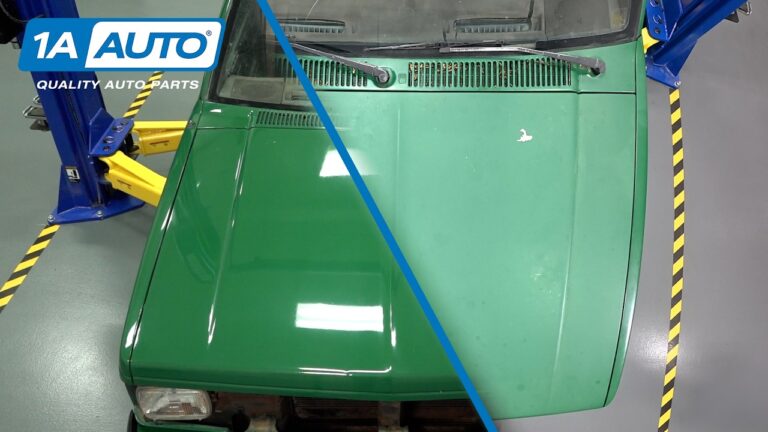 A technician applying a polishing compound to the hood of a faded Chevrolet S10 truck.